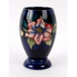 Moorcroft, a Clematis pattern vase, tubeline decorated to a blue ground,