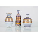 Mary Rich (British, born 1940), three porcelain bottles each with gilt light geometric detailing,