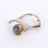 Manner of Wendy Ramshaw, a modern dress ring, set a circular moonstone cabochon to a curved setting,