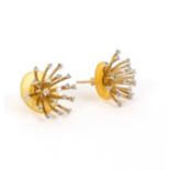 A pair of diamond set starburst earrings,