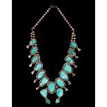 A silver and turquoise Navajo 'Squash Blossom' necklace, mounted,