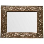 An Arts & Crafts style copper framed mirror, decorated stylised intertwined honeysuckle,