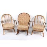 A pair of Ercol spindle back armchairs and an Ercol rocking chair similar,