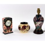 Moorcroft, a Honeysuckle pattern mantel clock, 16cm high, a baluster vase decorated flowers,