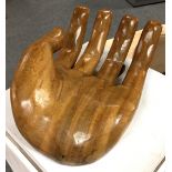 A carved wooden human open hand,
