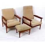 Guy Rogers, two teak reclining Manhattan open armchairs with cream upholstery and a single ottoman,