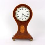 An Edwardian mahogany eight-day alarm mantel clock, in a balloon shaped case inlaid an oval patera,