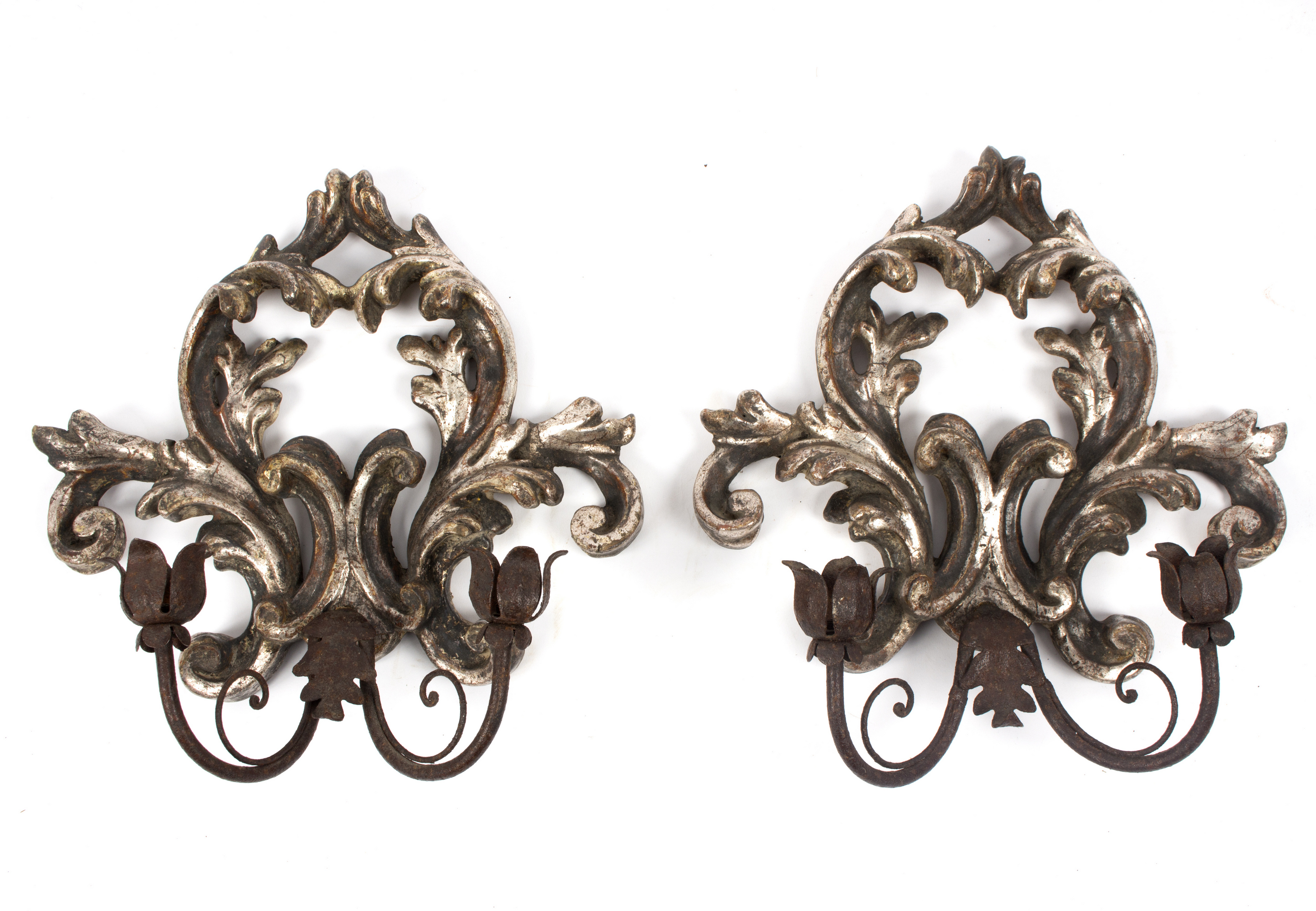 A pair of Italian silvered wall lights each with a sconce on the wall support,