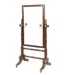 A late Regency mahogany cheval mirror with turned supports, set brass candle branches,