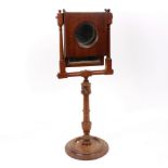 An early Victorian zograscope with a circular magnifier and turned column and base,