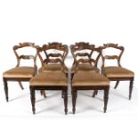 Six Regency rosewood dining chairs with carved cresting rails and horizontal splats to the backs,