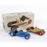 A German tinplate clockwork open-top car by Distler, the cream body with red interior and trim,