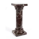A red and white veined marble column, the hollowed column on a square base,
