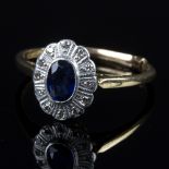 A sapphire and diamond cluster ring, the oval mixed cut sapphire approximately 0.