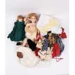 Two modern bisque head dolls and a quantity of dolls clothes etc.