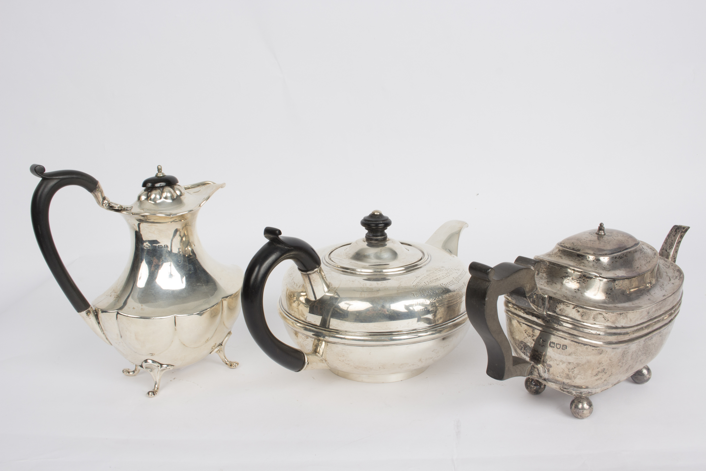 A circular silver teapot, WN, Chester 1905, with presentation inscription and ebonised handle,