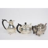 A circular silver teapot, WN, Chester 1905, with presentation inscription and ebonised handle,