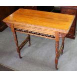 A late Victorian fold-over card table with galleried frieze, on turned legs,