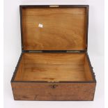 A Victorian walnut box with hinged cover and carry handles to the sides,