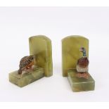 A pair of Austrian cold painted bronze birds mounted on onyx book ends,