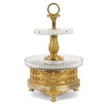 An ormolu and glass two-tier stand with engraved and applied decoration to the mounts,