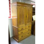 A late Victorian linen press, the upper section enclosed by panel doors,