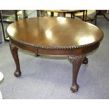 A mahogany D-end dining table on claw and ball feet,