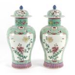 A pair of Cantonese green ground vases with panels of flowering branches,