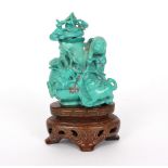 A small turquoise vase with cats and floral decoration, on a stand,