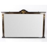 A late Victorian ebonised and gilt metal mounted overmantel mirror with central mask head applied
