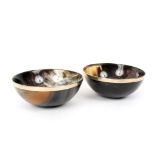 A pair of circular horn bowls with plated rims, 12.