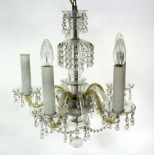 A Venetian style small glass chandelier with central knopped column hung prismatic drops,