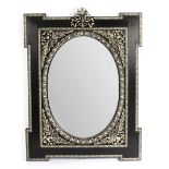 A silvered and ebonised wall mirror, the oval plate 96.
