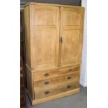 An oak linen press enclosed by panelled doors above two short and two long drawers,