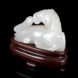 A white jade carving of a recumbent horse, 18th/19th Century,