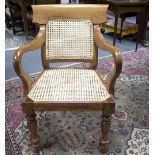 An Anglo-Indian open armchair with caned back and seat,