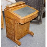 A Victorian walnut Davenport with stationery compartment to the back and bank of drawers to one