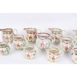 Thirteen moulded pink-lustred pottery jugs, in various sizes, moulded with stag hint scene,