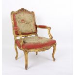 An upholstered fauteuil of Louis XV style with gilded frame and upholstered in Aubusson style