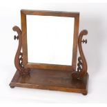 A Victorian mahogany dressing table mirror on scroll supports,