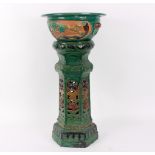 A painted terracotta jardinière on stand, emerald green glaze,