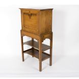 A student's early 20th Century oak secretaire with double platform beneath,