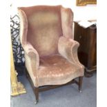 An 18th Century wing back armchair,