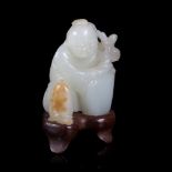 A pale celadon jade figure of a kneeling boy with a plant, 18th/19th Century, 4.