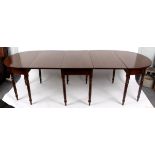 A Regency style mahogany D-end dining table, with central two flap section on turned tapering legs,