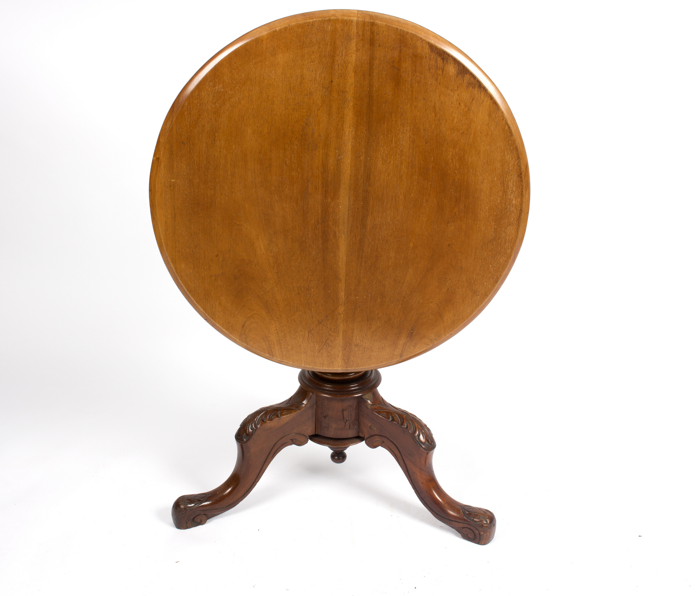 A circular mahogany table, on a turned column and carved tripod support,