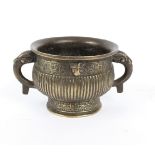 A Chinese bronze censer of Archaic form with reeded and scrollwork body, stylised bird handles,
