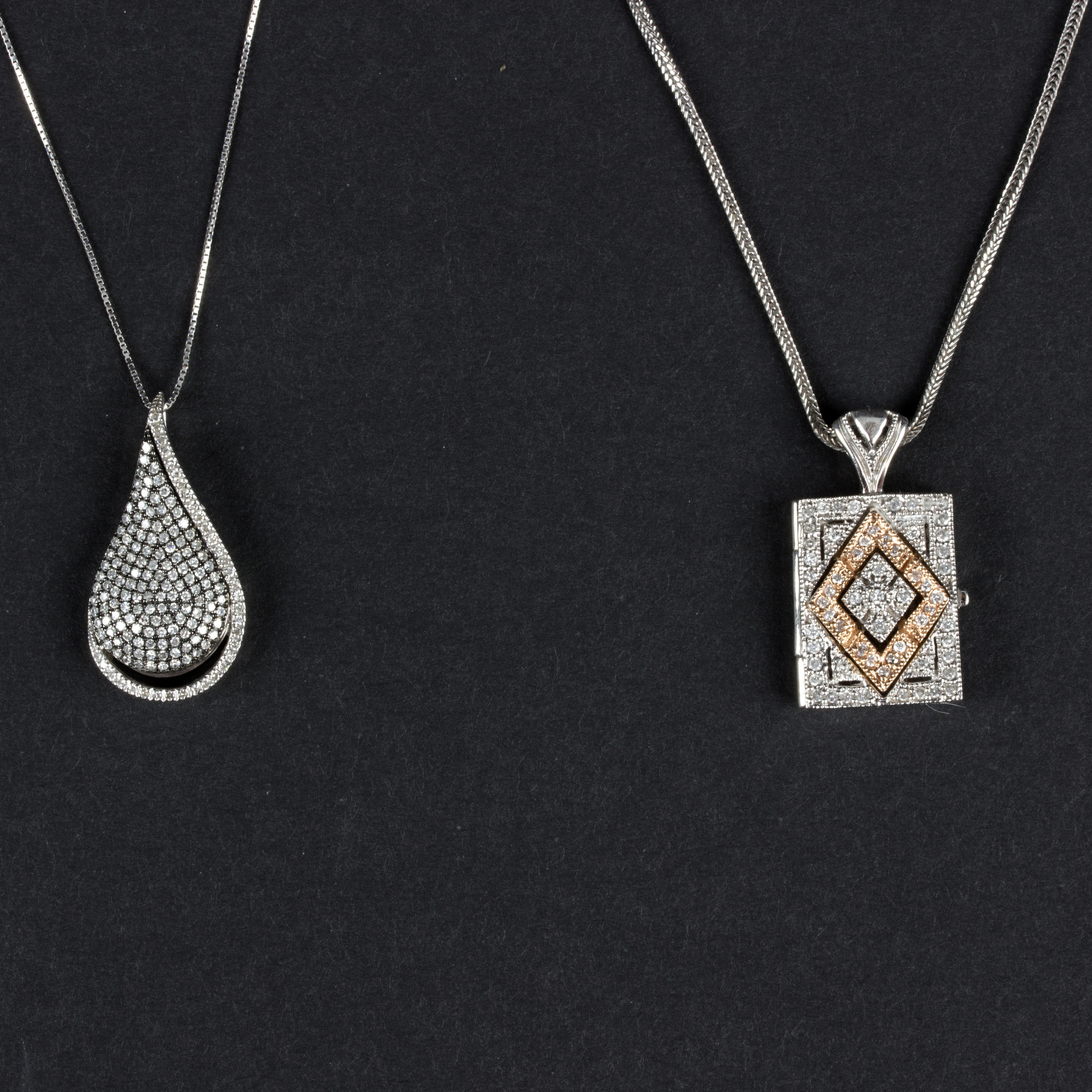 A diamond teardrop pendant with openwork back to a 14K white gold mount and chain and a 14K white