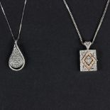 A diamond teardrop pendant with openwork back to a 14K white gold mount and chain and a 14K white