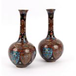 A pair of onion-shaped cloisonné vases, decorated panels of foliage,